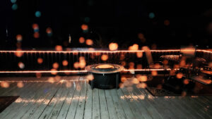 deck through raindrops on glass at night