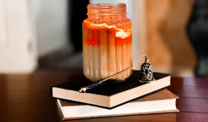 lit candle resting on books