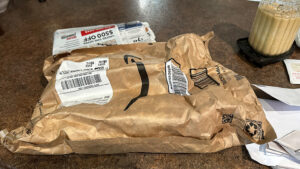 amazon envelope after being crammed into a mailbox