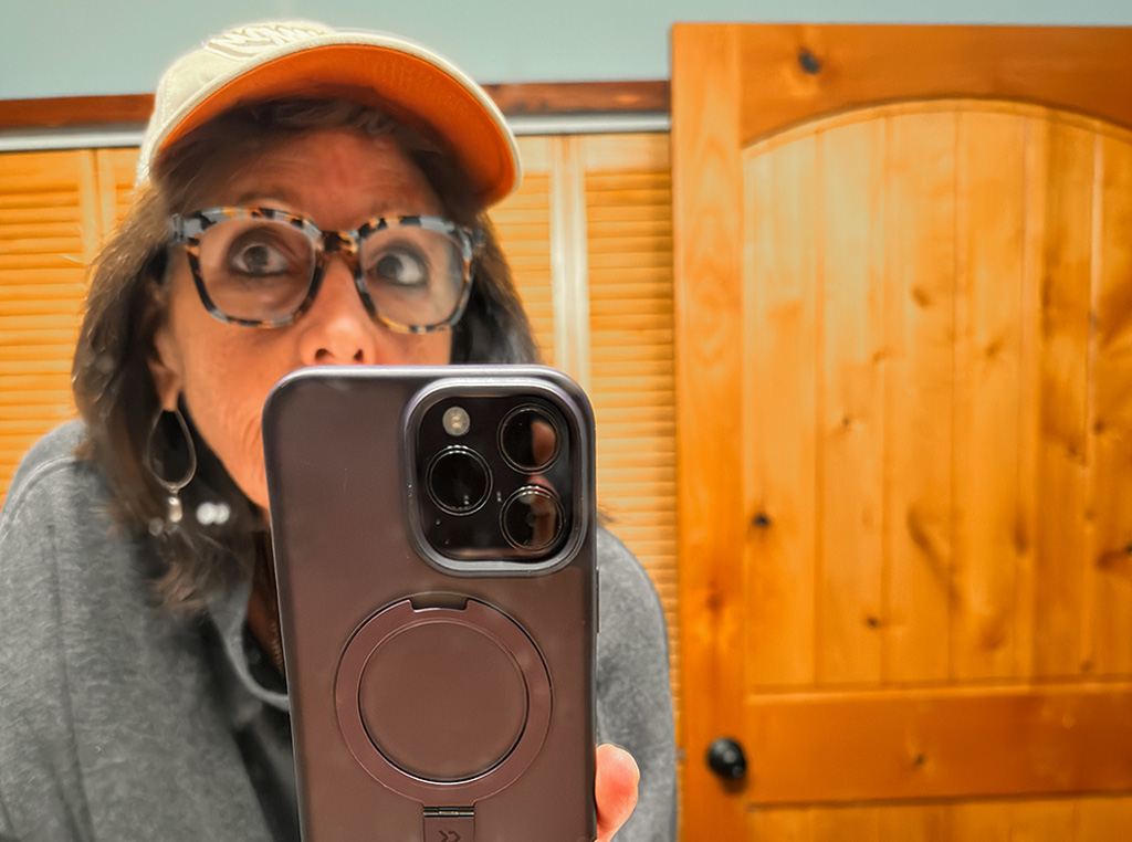 selfie wearing a hat to cover gray
