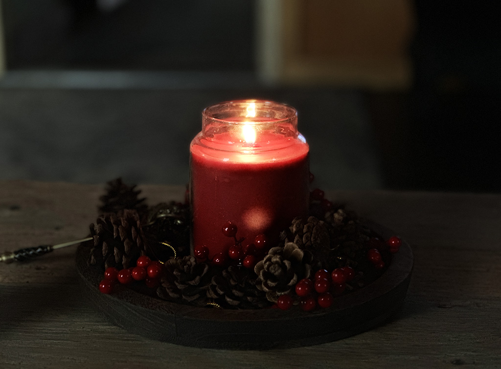 candle burning in a darkened room