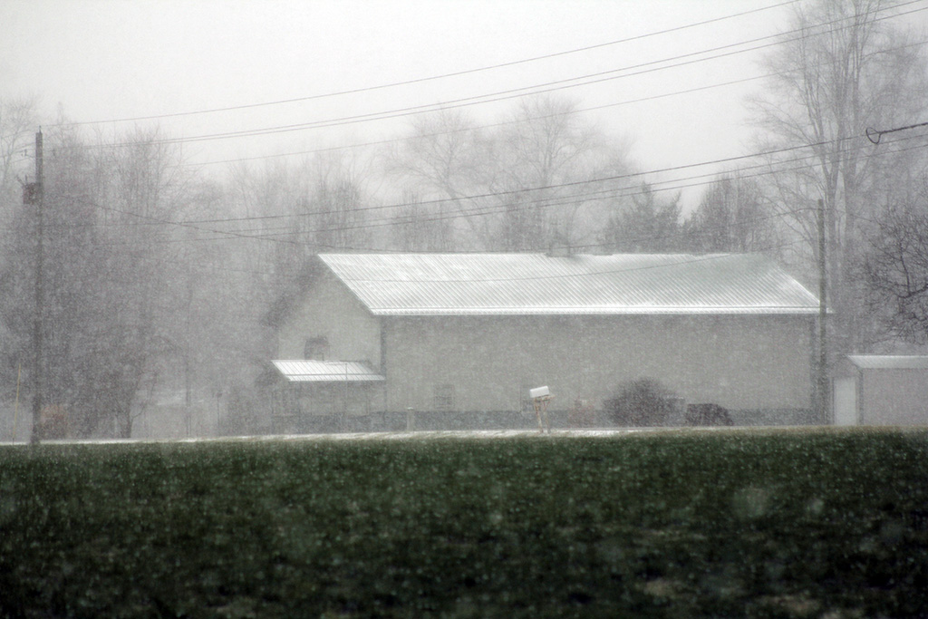 snowing and colder with wind